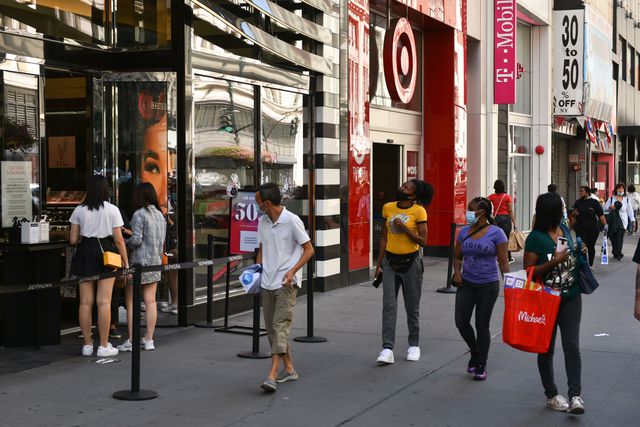 People on 34th Street outside a Sephora store are seen wearing masks